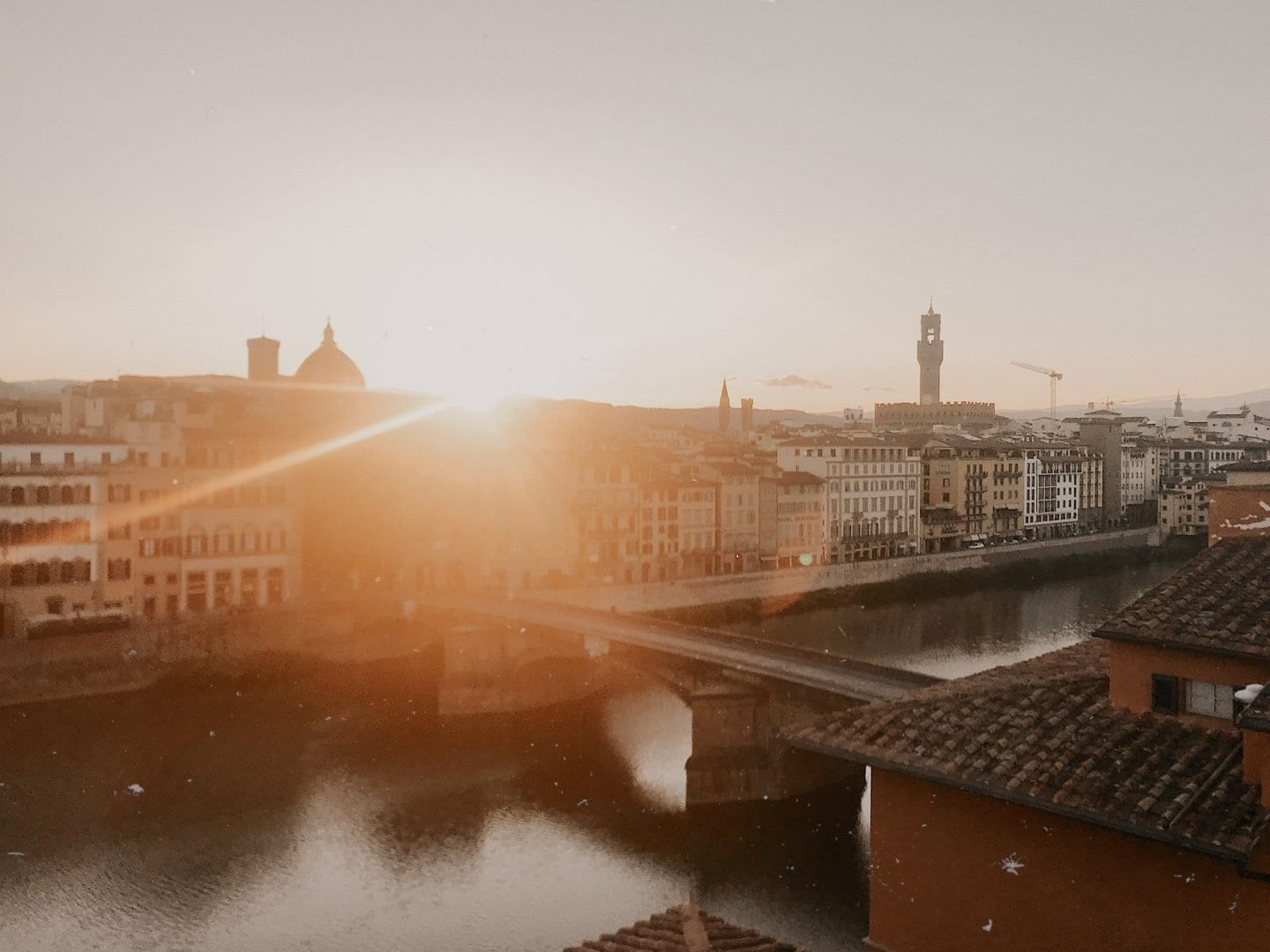 View from apartment of sunrise over historic European city buildings. Where to stay in Florence, Italy: Santo Spirito district