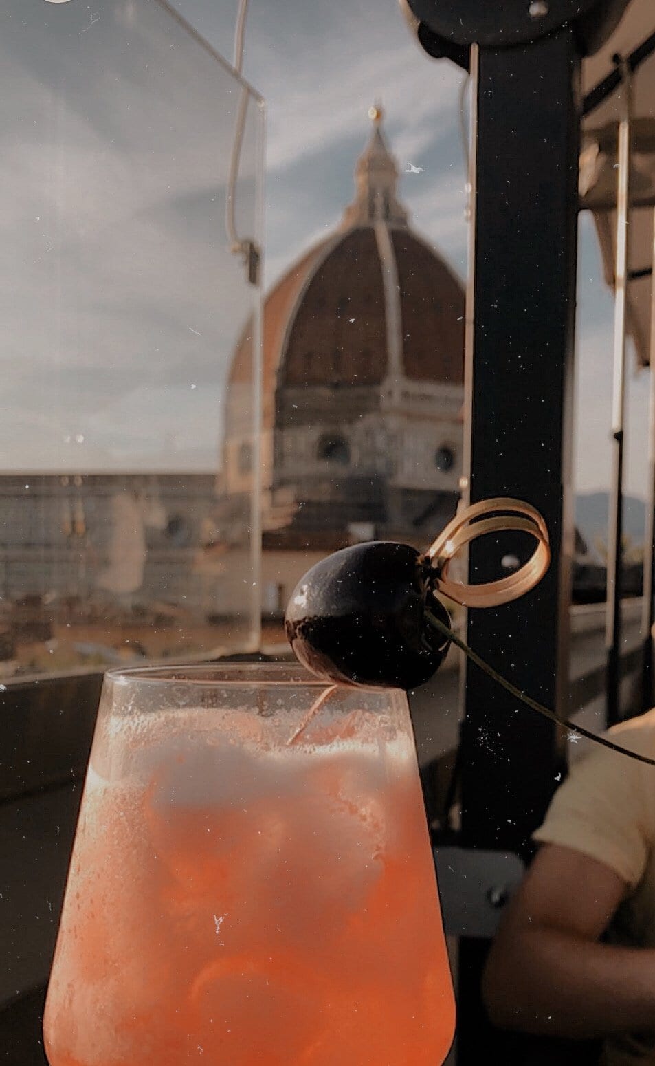 Cocktail with large domed church in the background. Where to stay in Florence, Italy - Grand Hotel Cavour