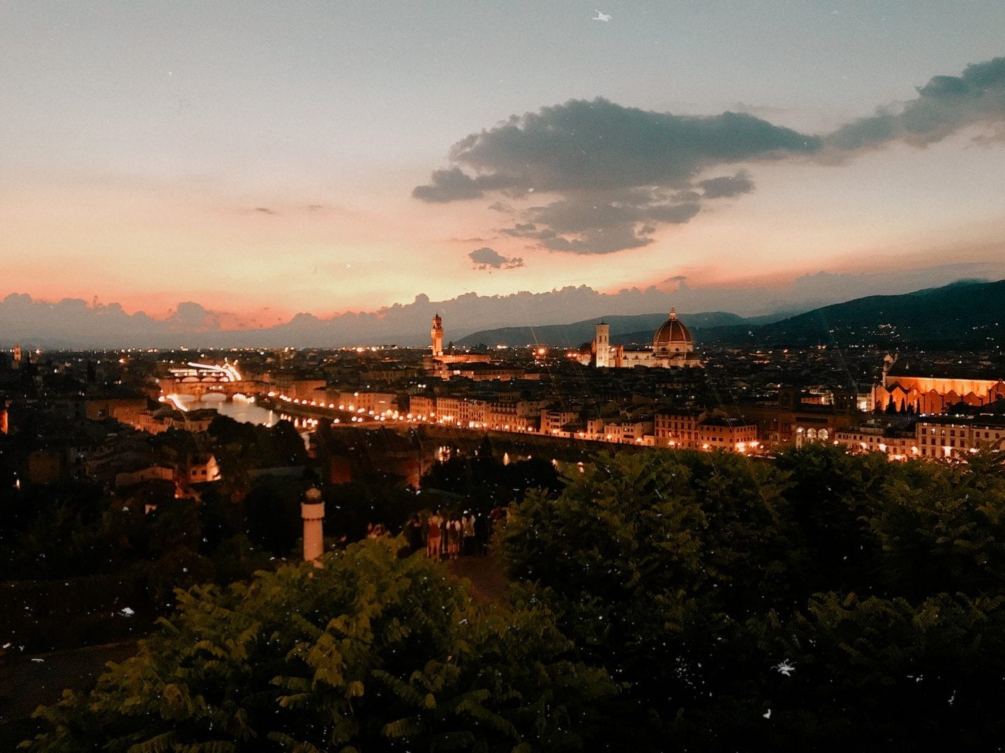 Nighttime view over European city with historic buildings and river. Where to stay in Florence, Italy: San Niccolò neighborhood