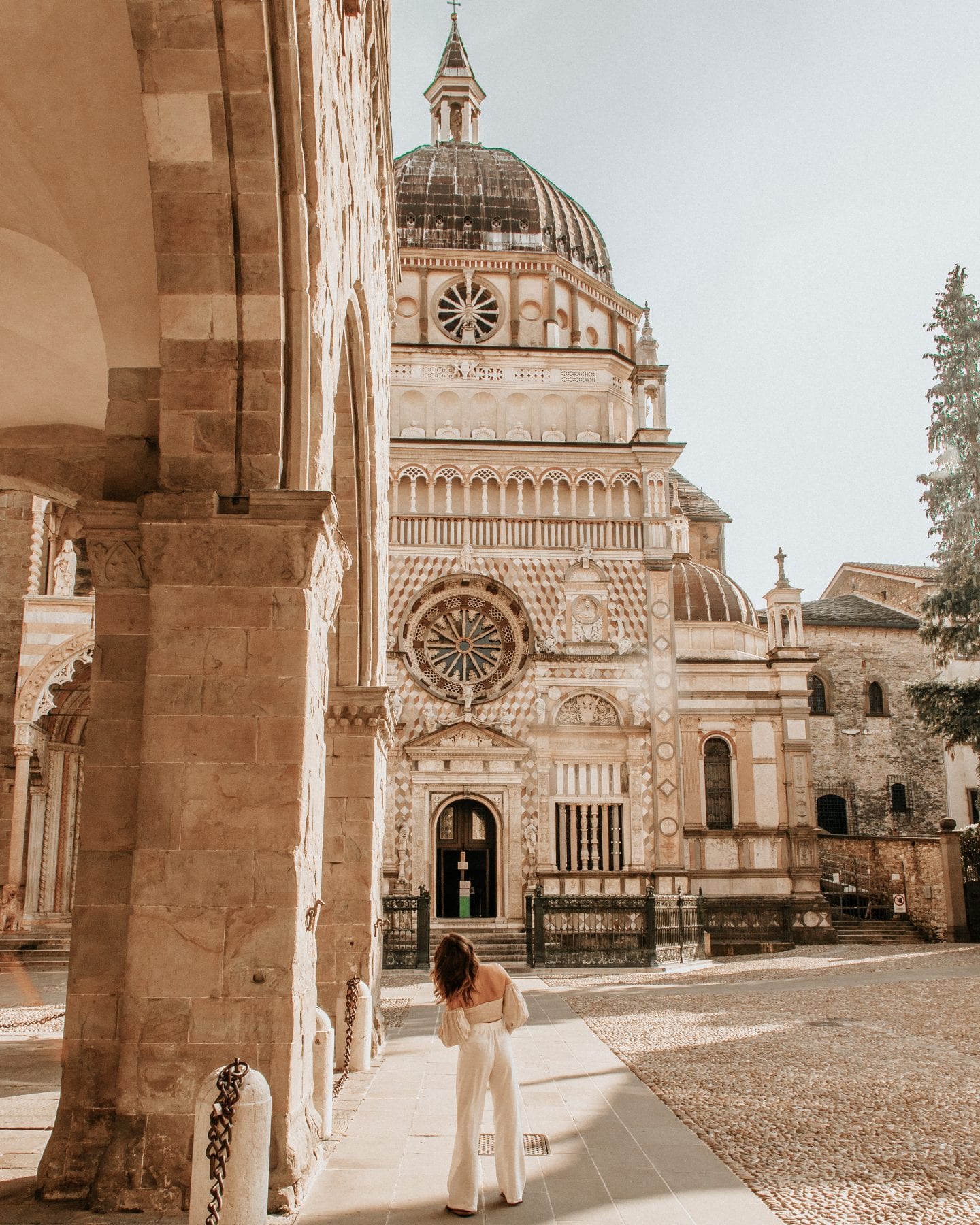 Photo of girl in front of Cappella Colleoni, a very decorated religious monument in Bergamo, Italy