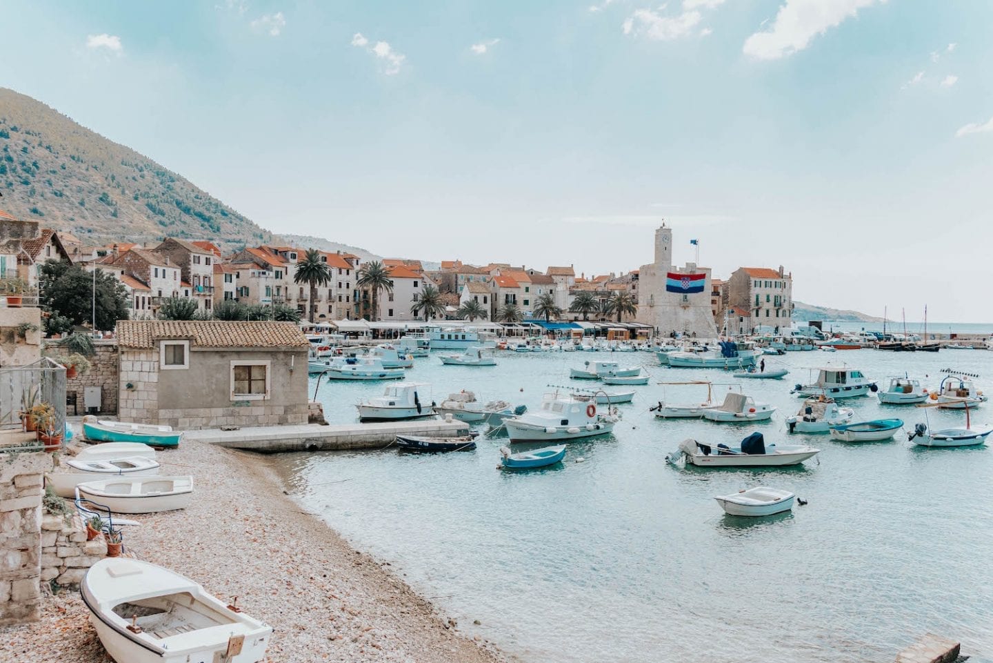 Croatian Island town on a bay with sand-colored, orange-roofed houses - Kozima, Vis Island, Croatia