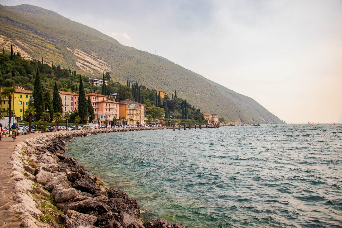 The water's of Lake Garda Italy touch the rocky shore of Nago-Torbole