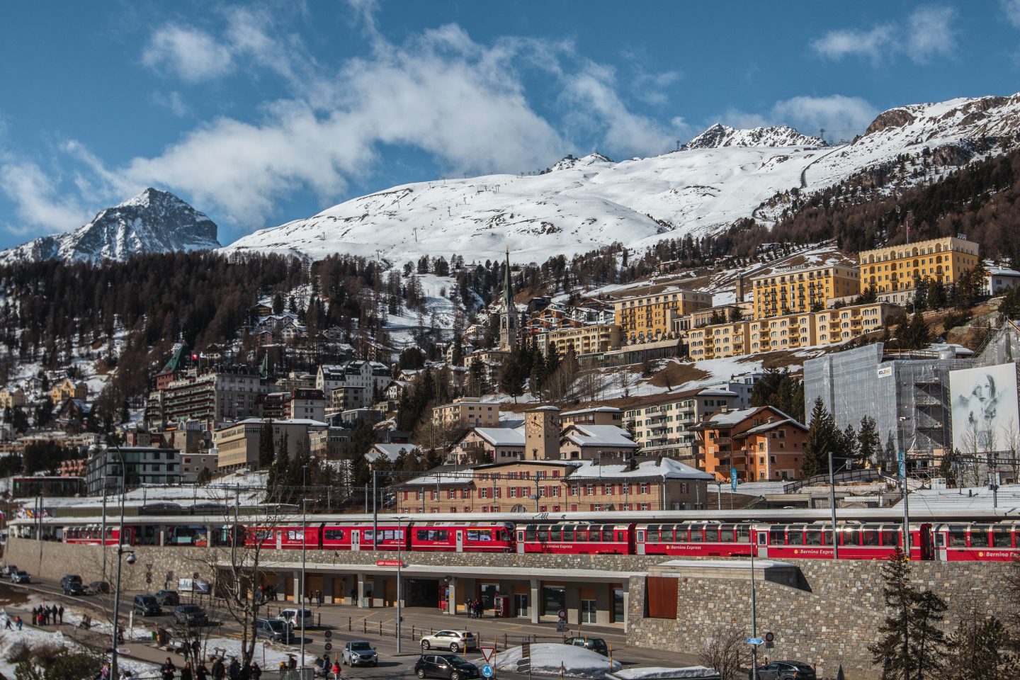 Red train in front of old town, St. Moritz, Switzerland