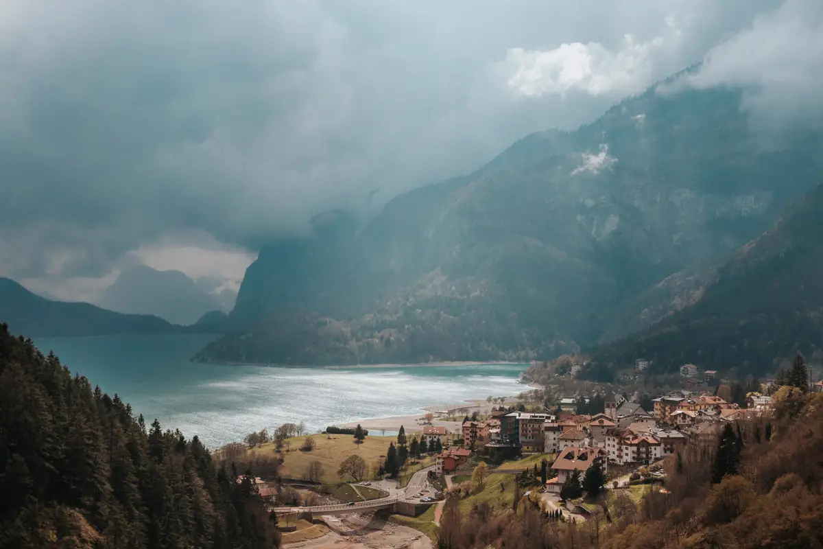 Lake Molveno, Italy. Tall mountains above a blue lake next to characteristic alpine houses.