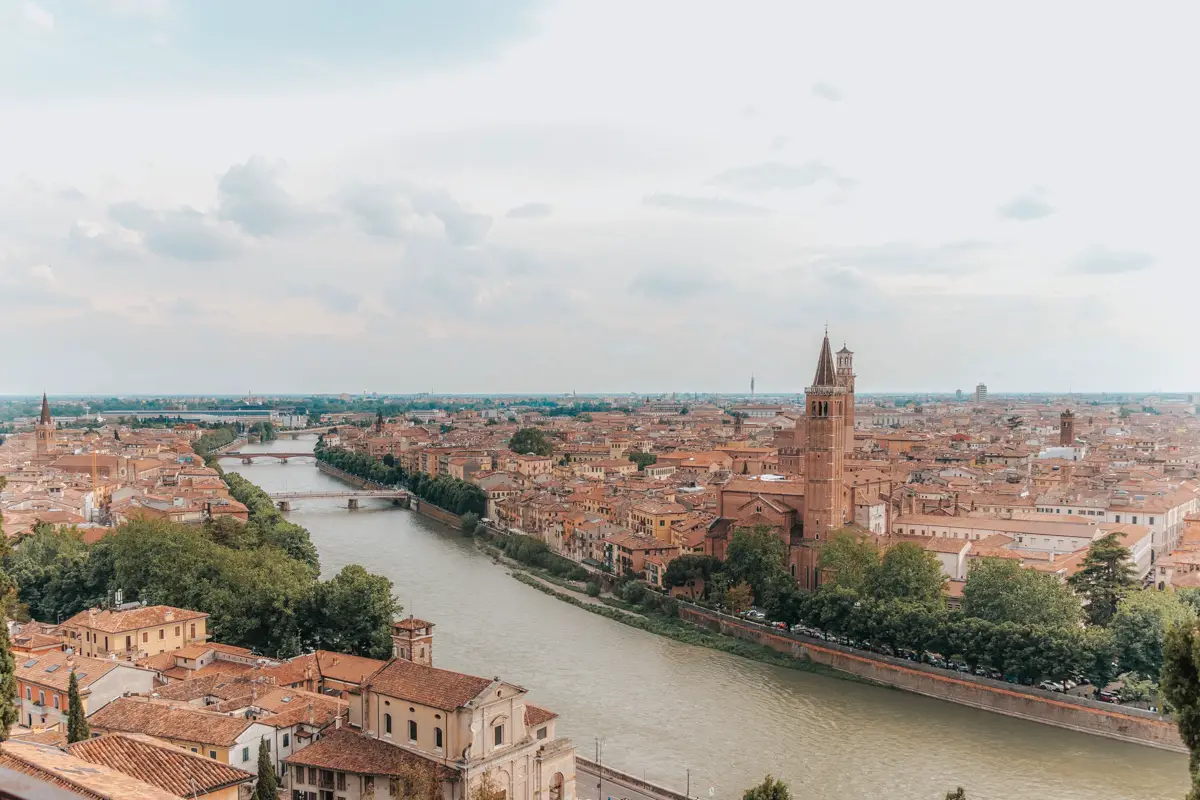 Bird's-eye view of the rose-colored, historic city of Verona, Italy and the Adige River that divides it