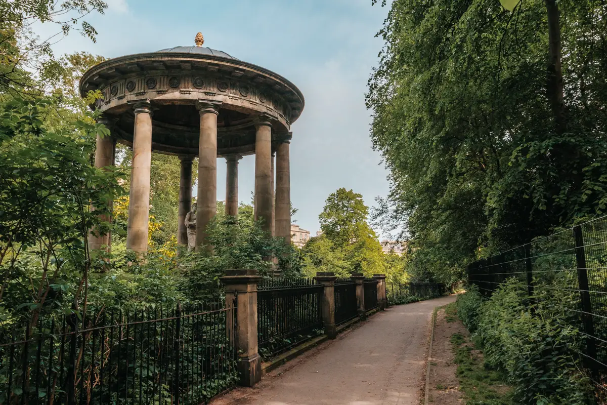 Rotunda monument along wooded path. St. Bernard's Well in Edinburgh, Scotland.