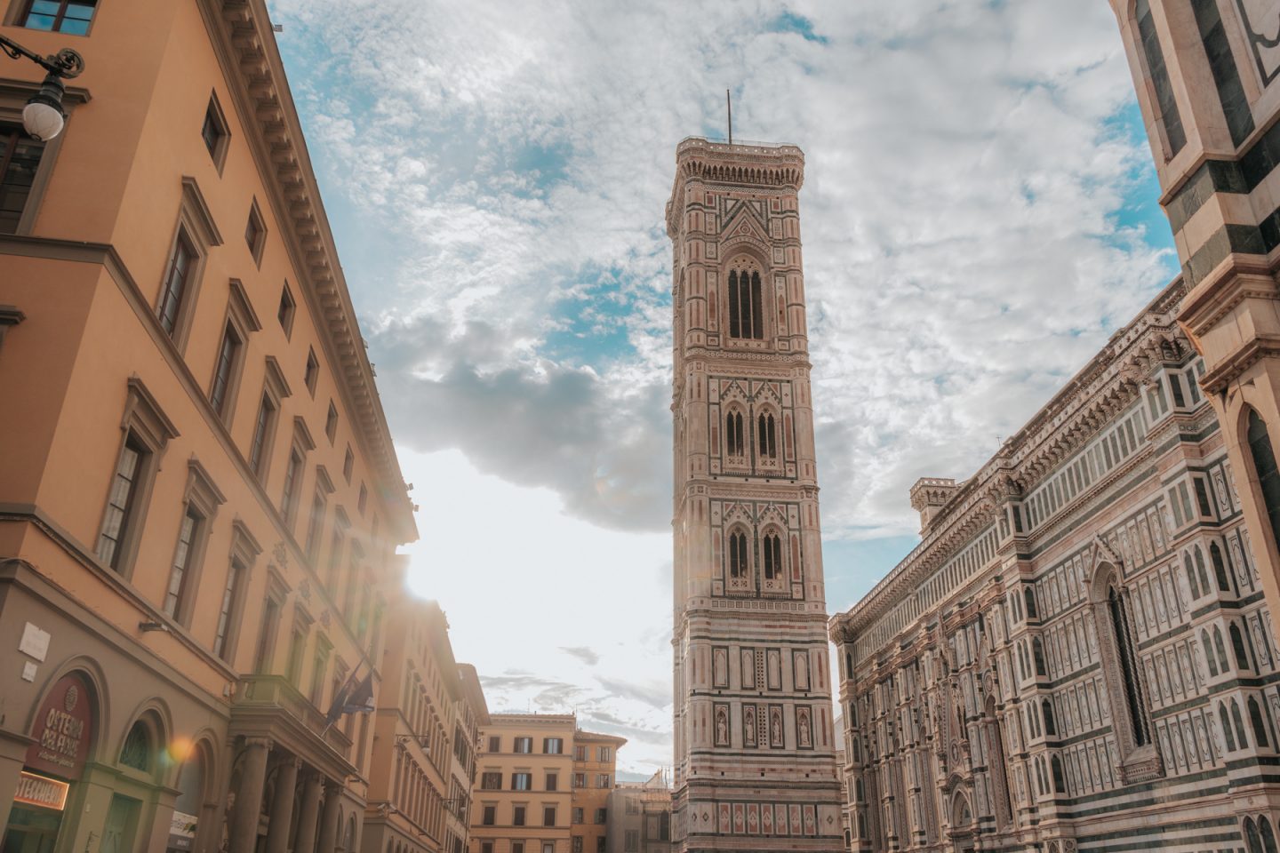 Ornate bell tower next to cathedral and other historic buildings. Where to stay in Florence, Italy: Centro Storico