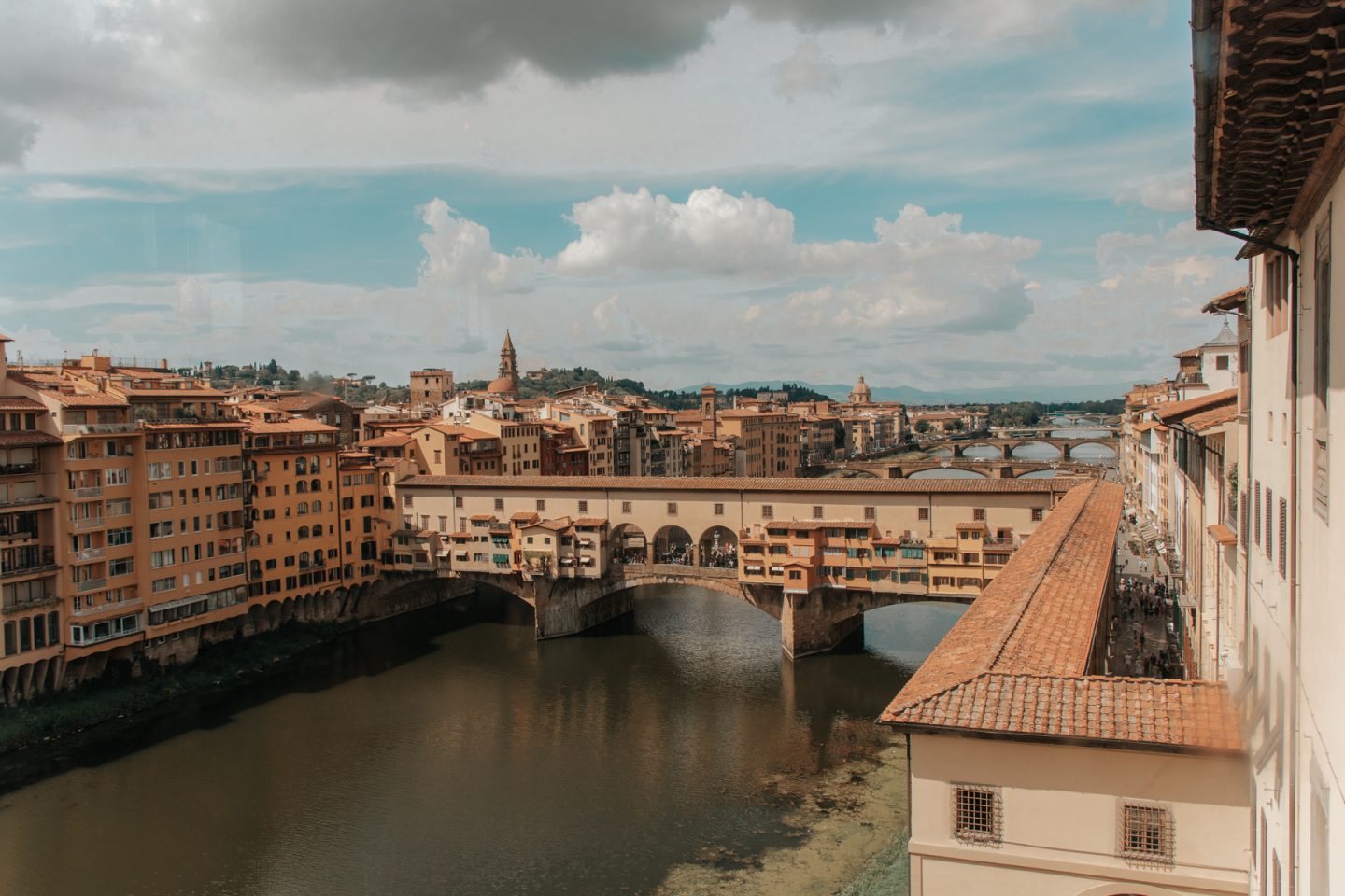 Bridge with buildings across wide river - Ponte Vecchio, Florence, Italy